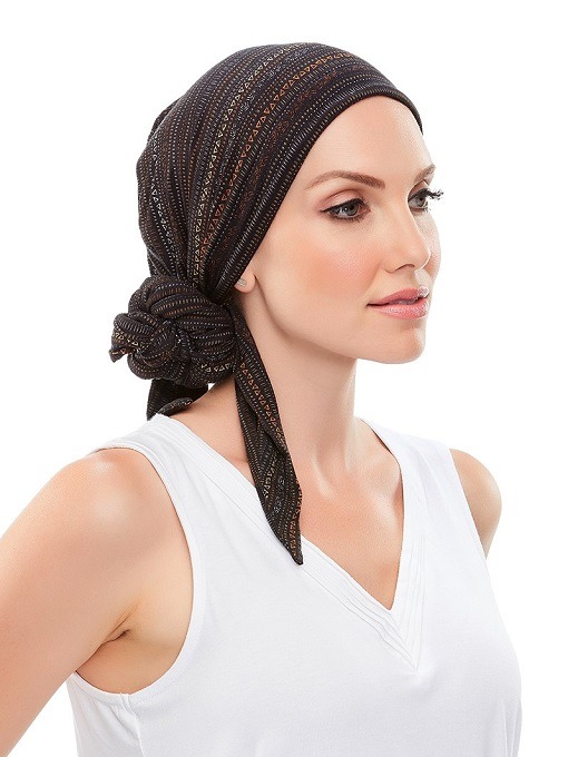 Lady wearing a softie headwrap in black with white dots