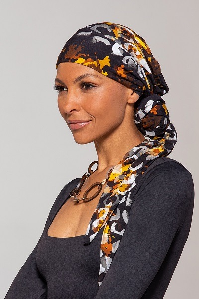 Lady wearing the royal cheetah softie hear wrap by Jon Renau